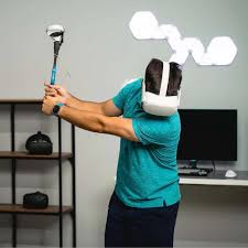 Person playing golf in a VR simulator with a panoramic indoor setup